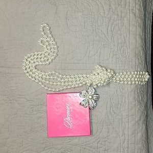 Works Premier Designs faux pearl strand with brooch.